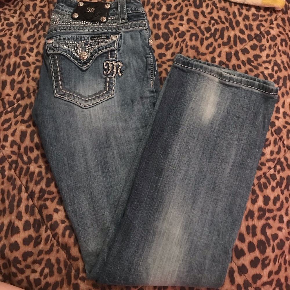 blinged out & distressed miss me boot cut jeans .
